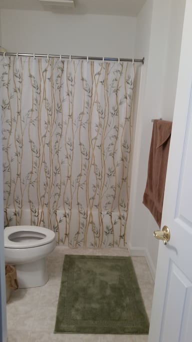Private bathroom with shower, towels, and travel sized amenities should you need them.