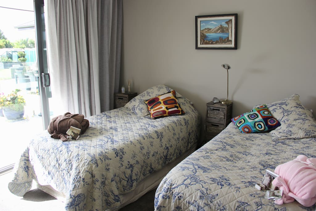 Ashley room with pool & garden view. Super single twin beds. Shared bathroom with spa bath.