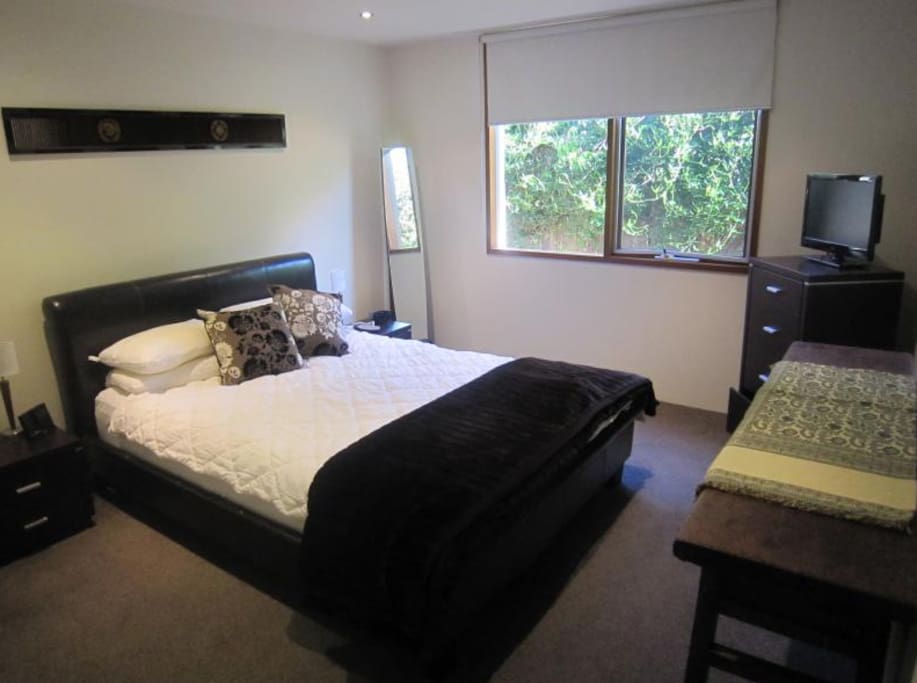 Bedroom 1 with built in robes and queen bed. TV with foxtel