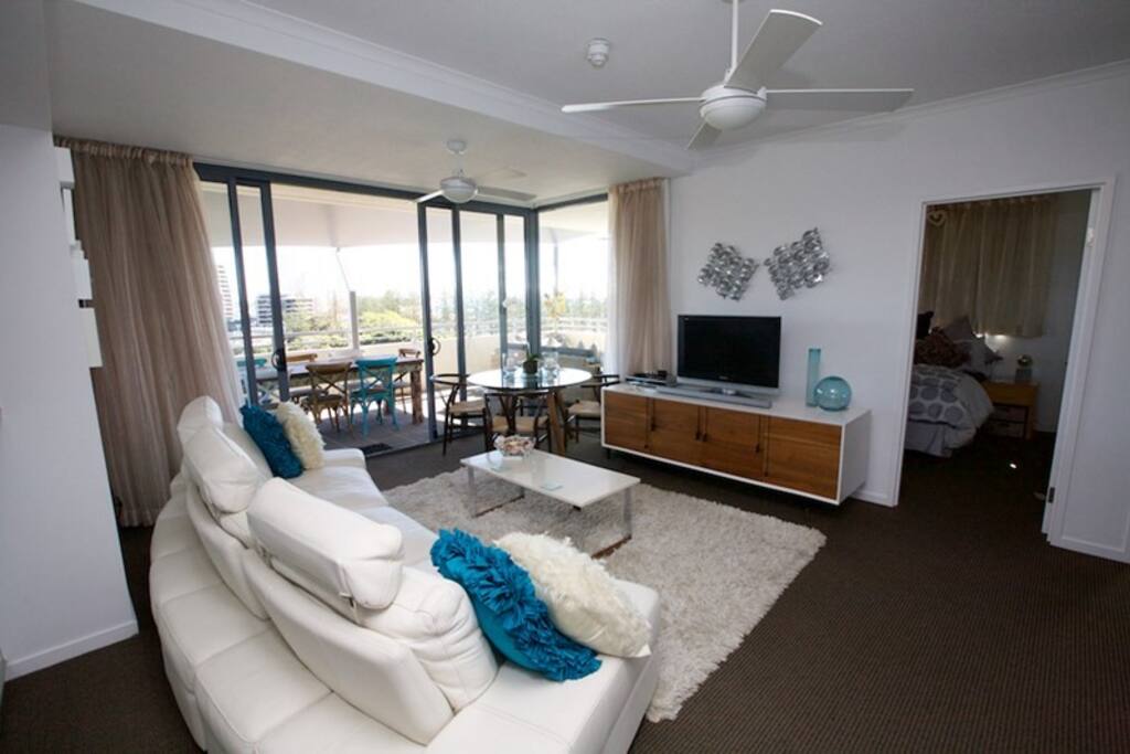 Gorgeous leather lounge & genuine art work enhance this breezy lounge/dining area with fantastic ocean vista.