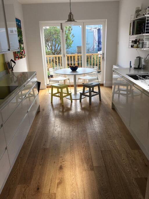 Kitchen with bi-fold doors onto garden terrace