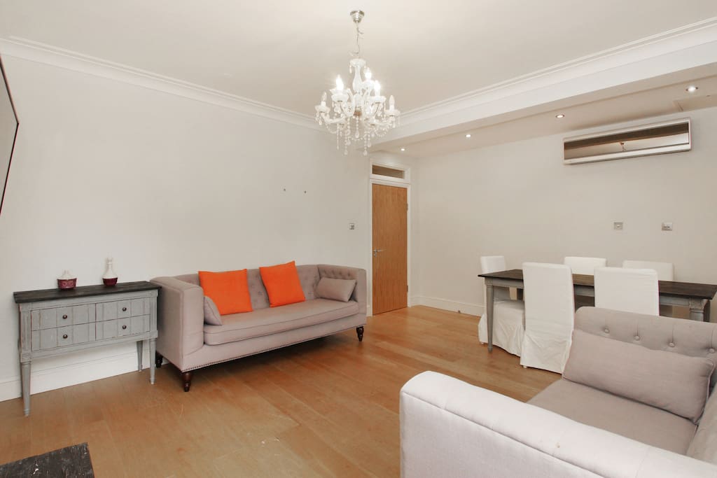 The exceptionally spacious Lounge with sofas, dining table and chairs and TV with satellite channels