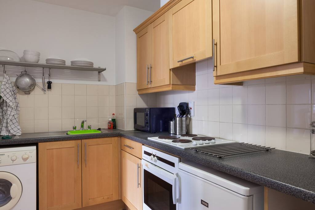Kitchen with cooker,hot plate,micro wave,washing machine,fridge....