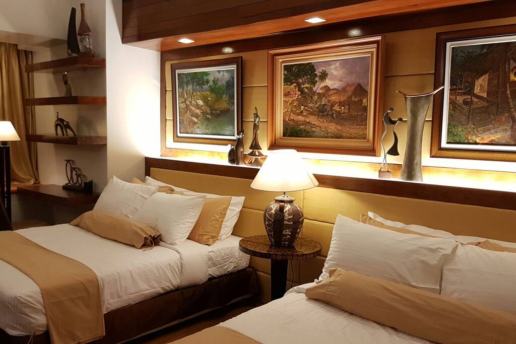 Two queen size beds fitted with duvet and soft pillows.