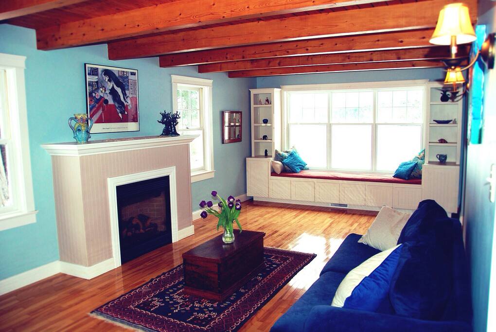 Living area with two sofas and a window seat looking over the lake