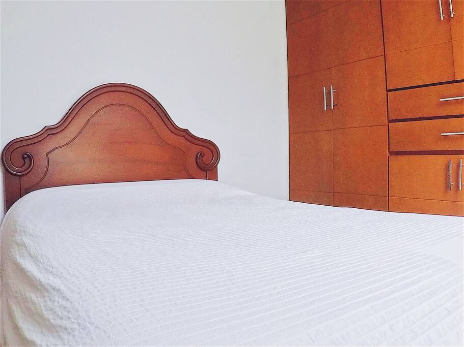 Private bedroom with closet, table, and tv with DirecTv