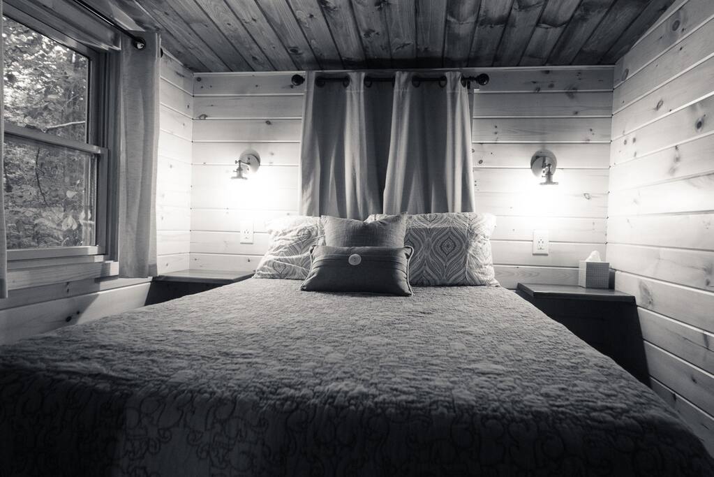 Enjoy your bed nestled in the forest in a room you can stand up in! At the entrance the ceiling is 6 feet tall, gently sloping downward as you reach the head of the bed.