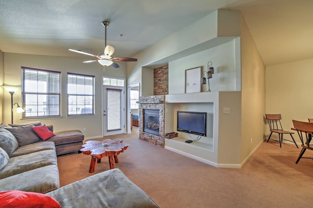 The living room features a large, plush sectional, gas-burning fireplace and a flat-screen cable TV.