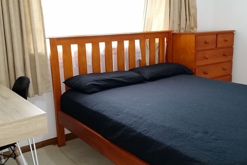 Clean and tidy bed with tall boy