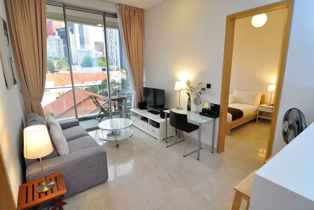 Living room has cable TV, wifi, large balcony, and an open kitchen that seats four.