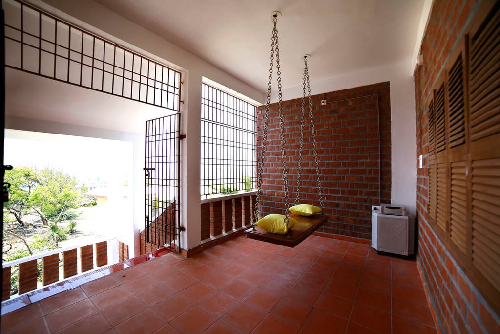 The sit-out with this beautiful swing is the perfect spot to sit and sip a coffee or to sit down with a loved one, as you take in the sight and sounds of the beach. This cozy corner is a common area that you can use irrespective of the bedroom you book
