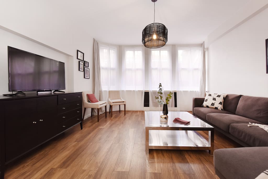The attractive interior-designed Lounge with large L shape sofa, TV, Freeview, Free WiFi and large windows