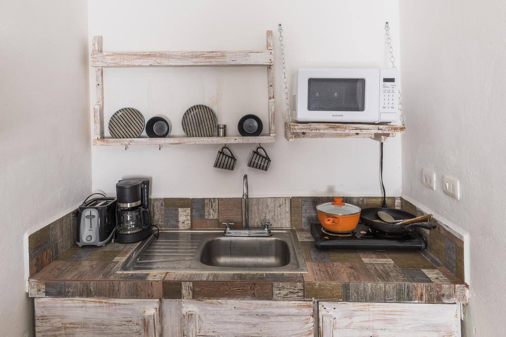 Kitchenette with microwave, mini fridge, electric stovetop, coffer maker and toaster