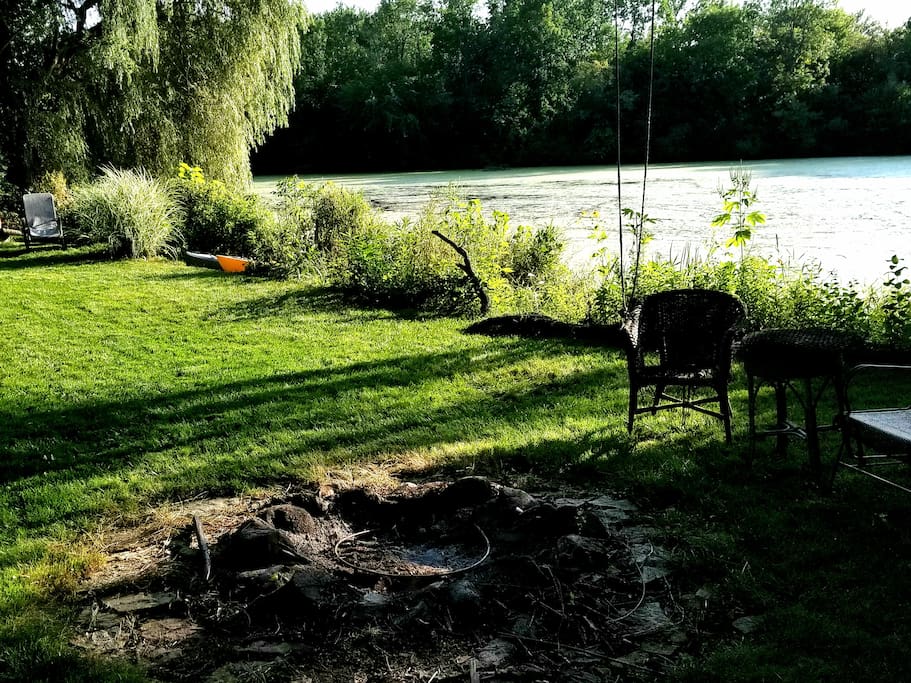 Fire Pit and furniture by the water and hammock under the willow tree!