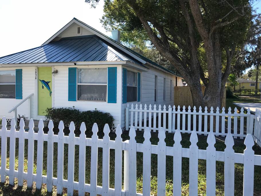 Enclosed white picket fence with two gates