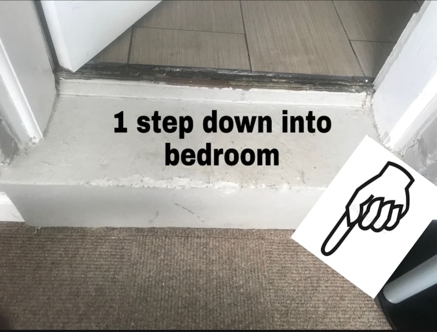 Go through kitchen - one step down to enter bedroom.