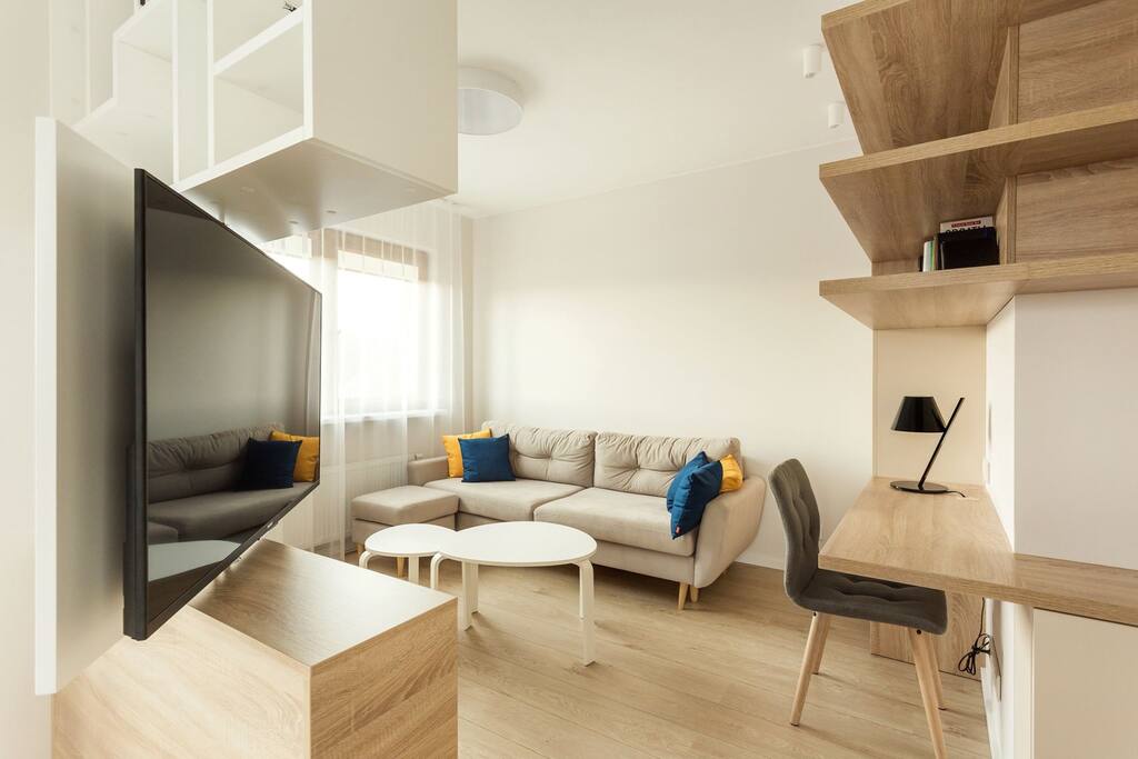 Beautiful, comfortable and light filled living room with plenty of space to relax after a day of traveling or shopping.