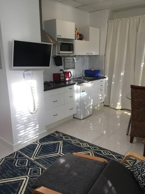 Well equipped kitchen, utensils and tv on the wall