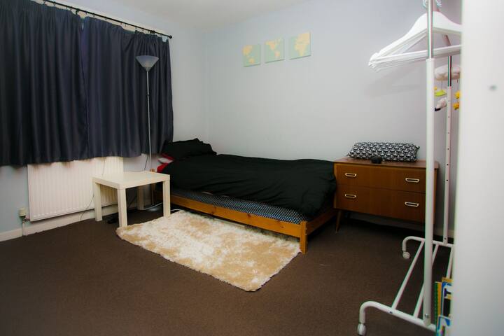 Spacious room in family home. No additional fee.