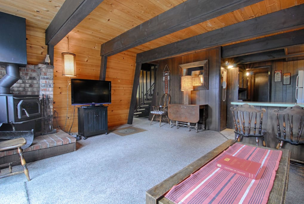 Living room with wood stove and Flat TV