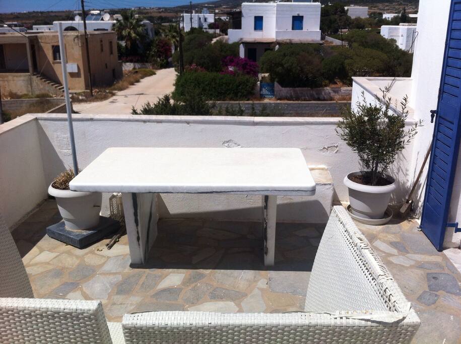 Nice balcony with a view and a big marble table to eat all together..