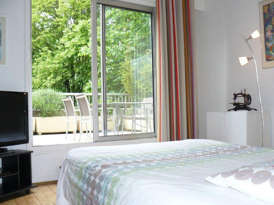 La chambre donne sur la terrasse et le parc
