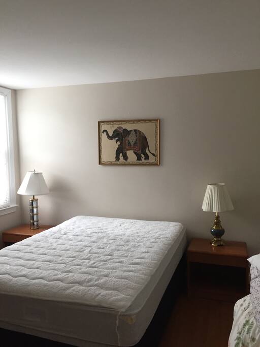 Queen size bed near window