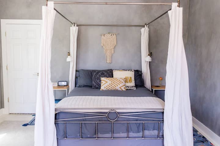 Queen bed with luxury sheets & canopy drapes for added comfort
