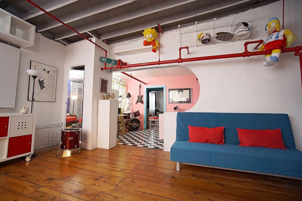 Comfy Queen Futon Sleeper Sofa and 12ft ceilings with exposed pipes and original wood flooring