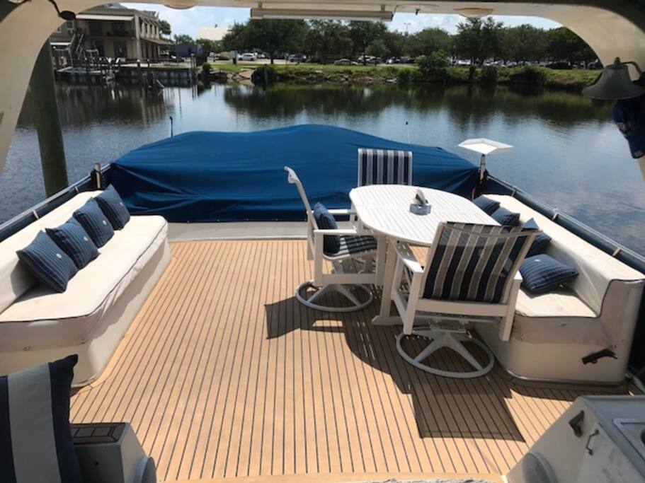 Looking aft, upper deck, easily seat many. The area under the blue canvas is a bunny bed for sunning.