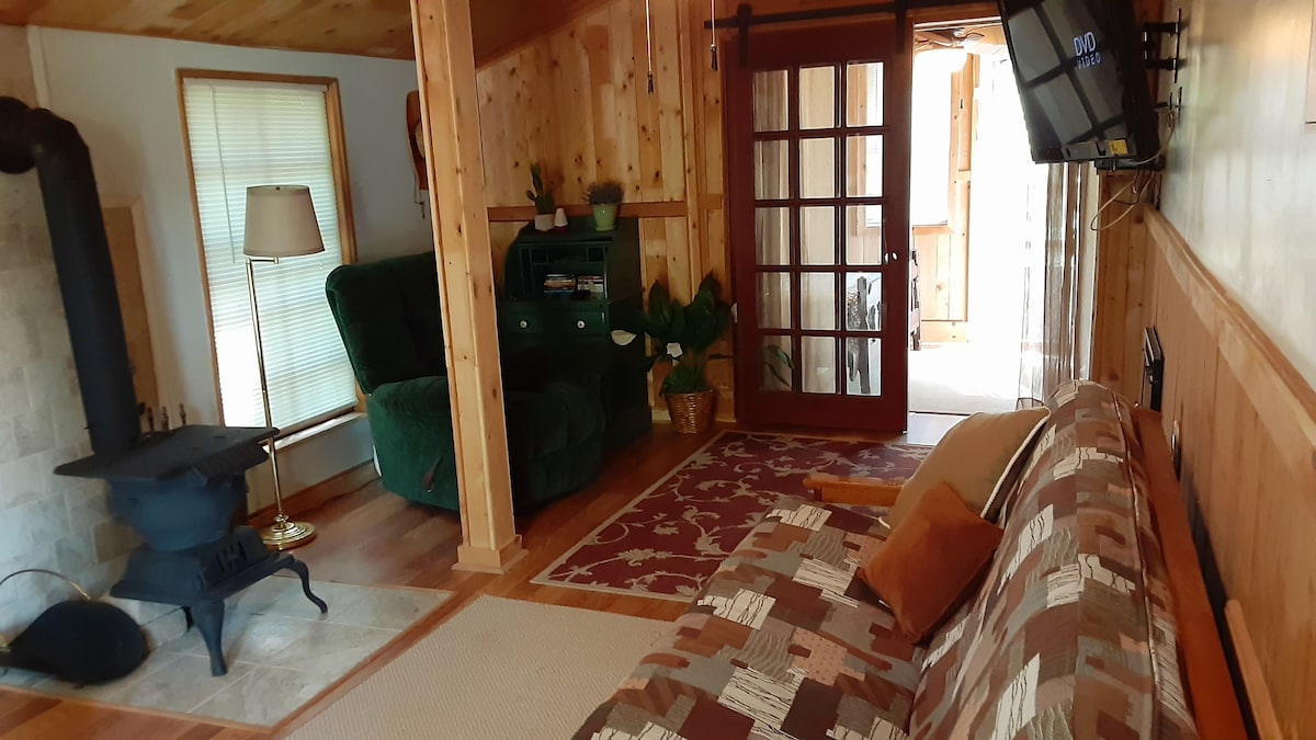 Kabinë kryesore me divan futon dhe çlodhje. Gjithashtu tavolinë ngrënieje