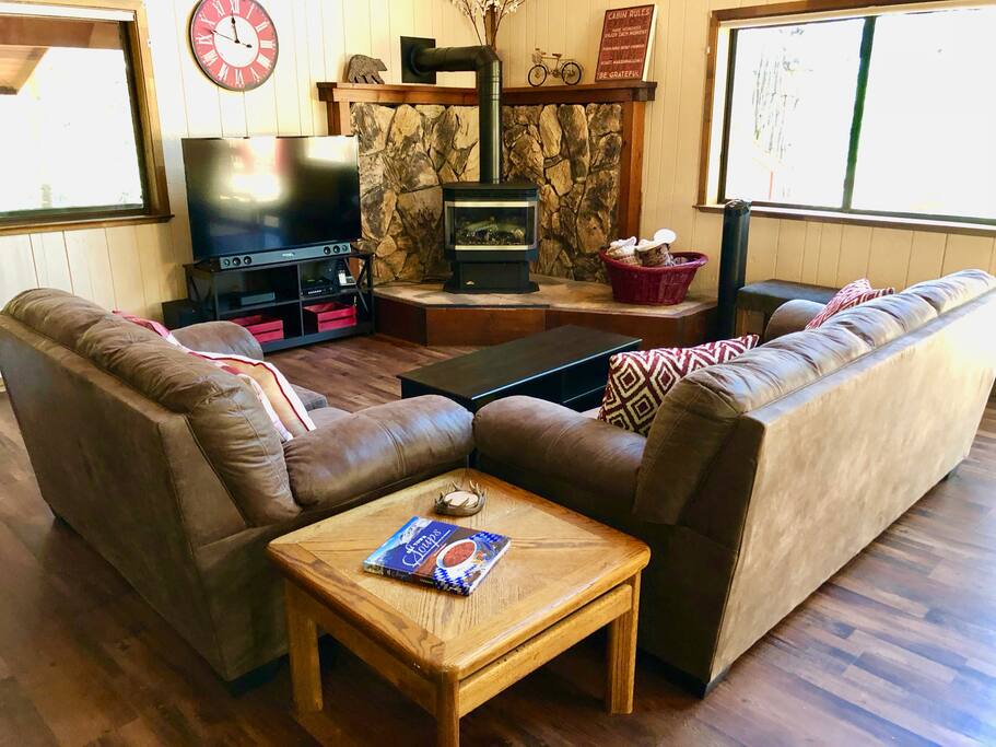 Gather around the TV and fireplace in the living room with a huge vaulted ceiling
