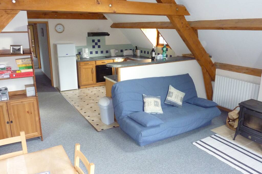 The open plan living area has a large well equipped kitchen
