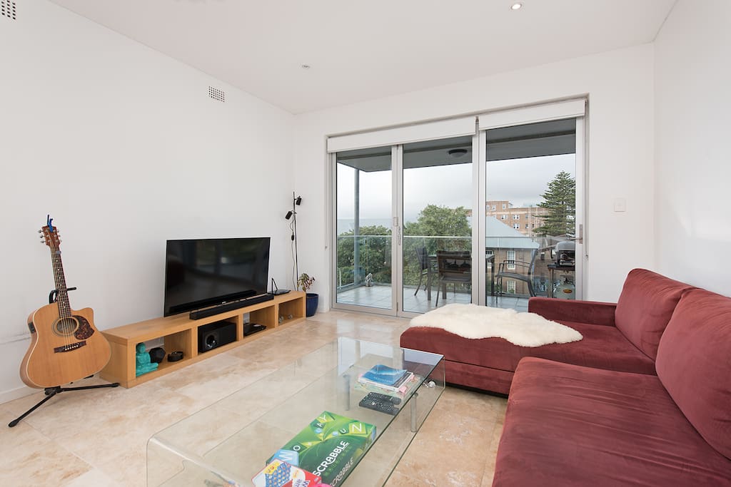 Open plan living area with balcony overlooking Bondi Beach