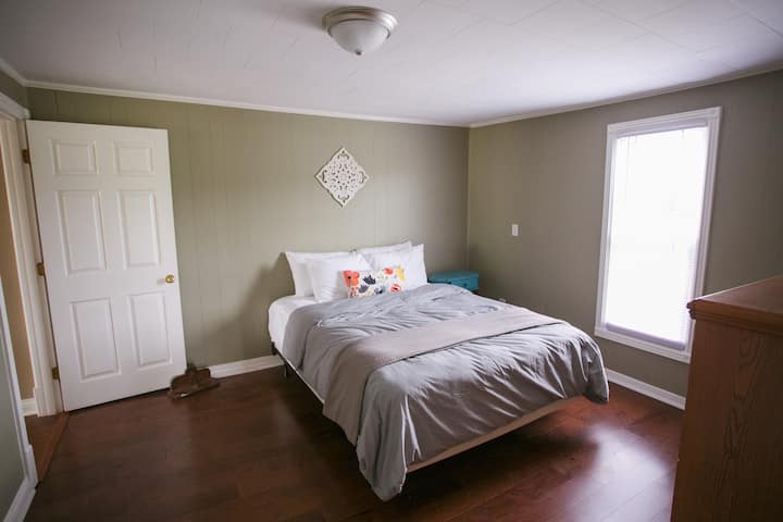 Queen size bedroom downstairs with fresh linens provided.