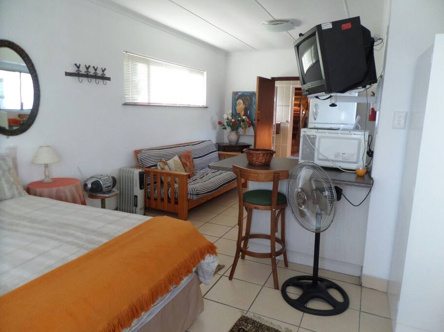 Unit 2: interior with double bed, breakfast counter and en-suite bathroom