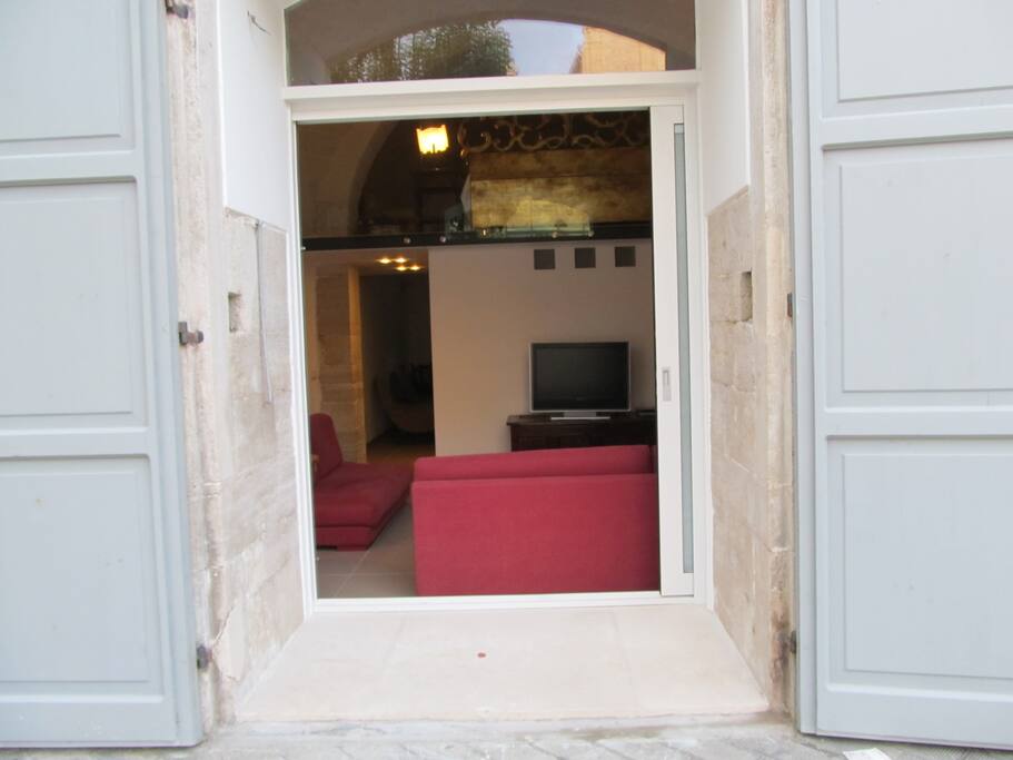 Living room with a big door window looking the square