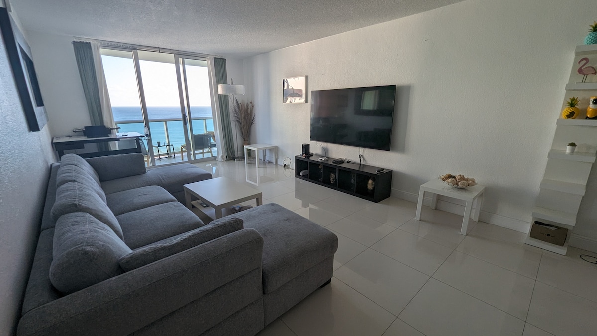 Step into the inviting living room, a cozy space filled with natural light and comfortable seating. Perfect for relaxing, bonding, and savoring beachfront living.