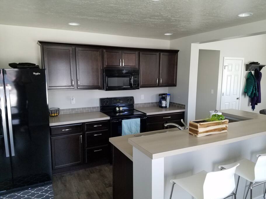 Shared Kitchen with bar stool seating and dining table