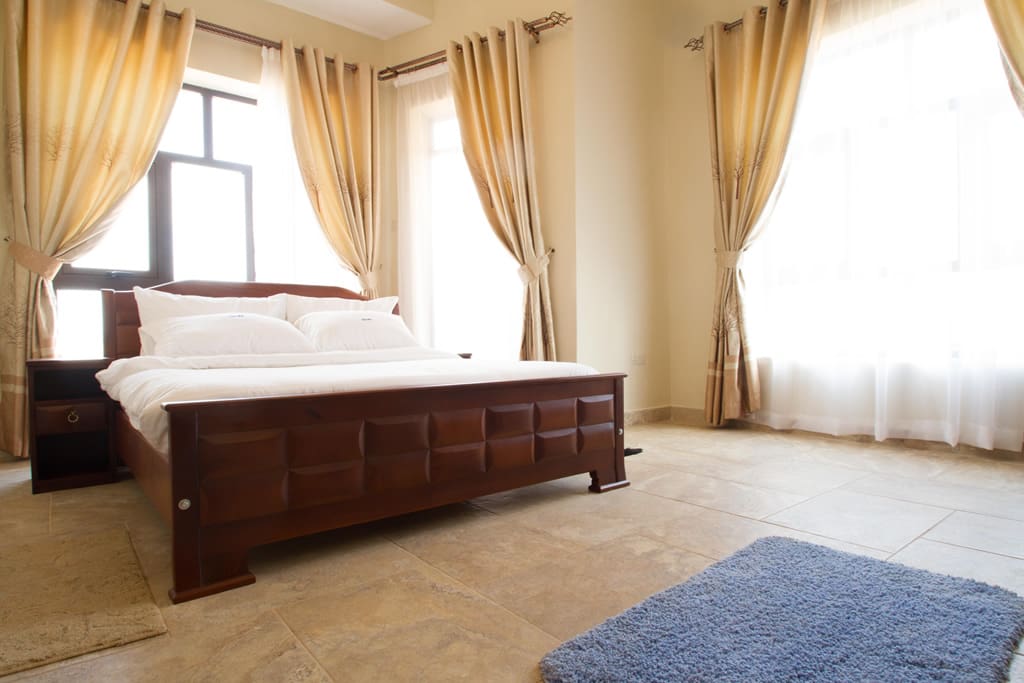 Master Bedroom with a queen bed, TV, large walk-in closet, own bathroom, and beautiful door that opens out into a beautiful Juliet balcony.
