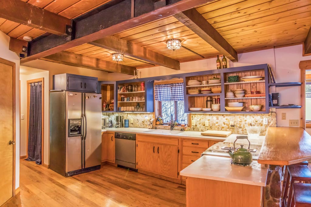 large open kitchen with all the necessities, coffee pot, crock pot, pots and pans etc.