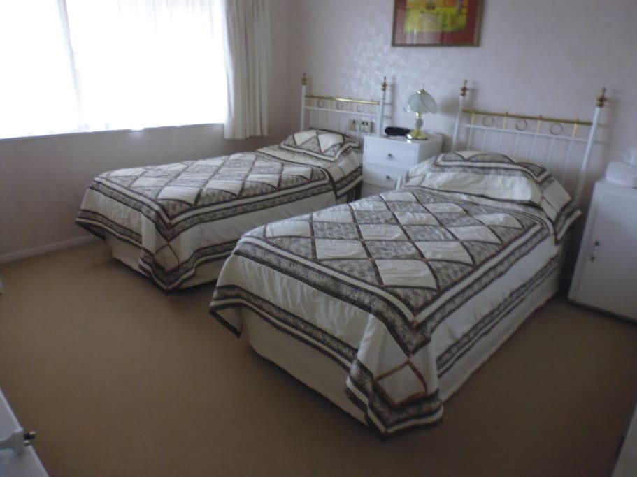 Two single beds, with a sink in the room