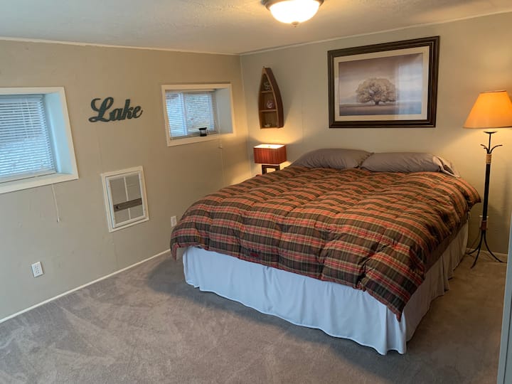 Guest bedroom with King bed and sliding door to deck and hot tub