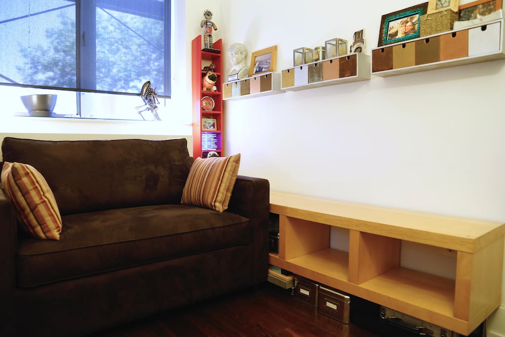 Cozy private bedroom furnished with folded clothing storage and a closet