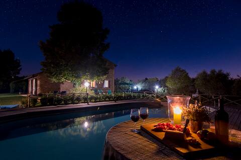 A farmhouse nestled among gardens and olive trees
