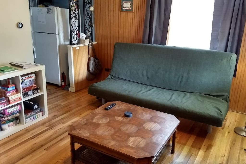 Living room with TV, PS4, board games, and disc golf discs