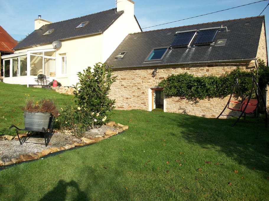 The back of the acomodation, there is a sheltered lower terrace which is a sun trap, with steps up to the garden