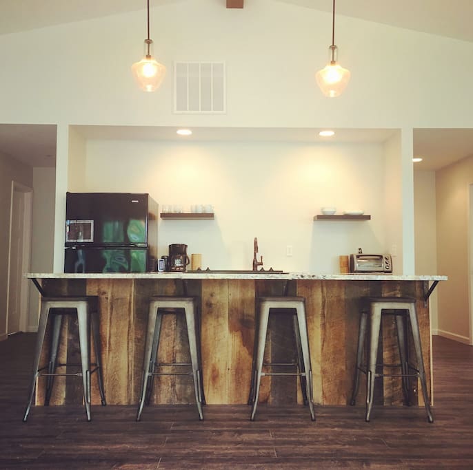 Large kitchen island made from the barn's original barn wood siding