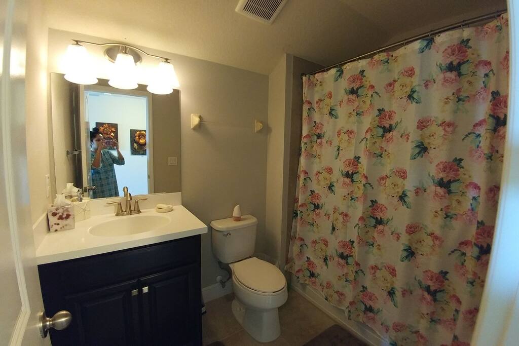 The bathroom next to the bedroom. Sink, Wc, and tub.