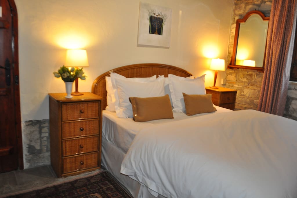 Cosy room with king-size bed looking out onto garden.